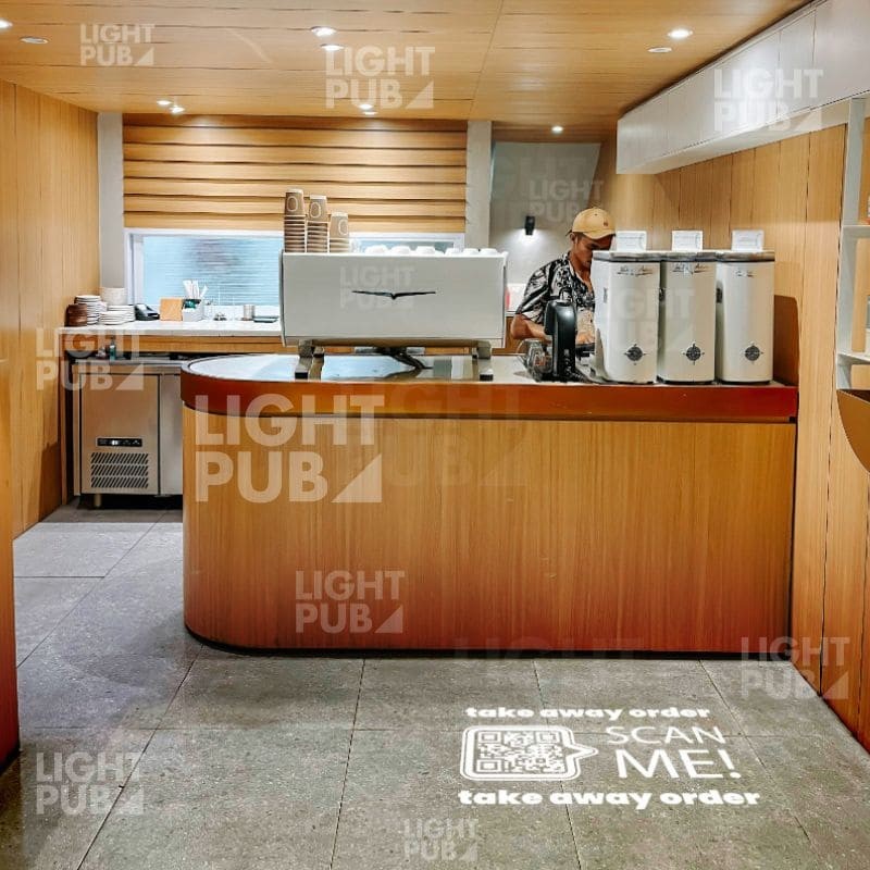 Beleuchteter QR-Code auf dem Boden für phygital im Restaurant